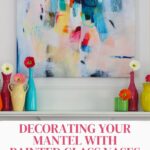 colored glass painted vases with zinnias on mantel