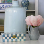 painted decorative box on table with flowers