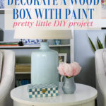 painted decorative box on table with flowers